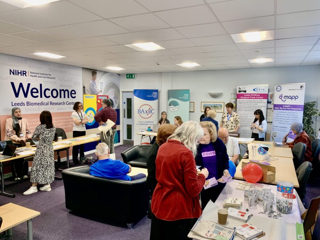 An image of attendees congregating around stalls at the event.