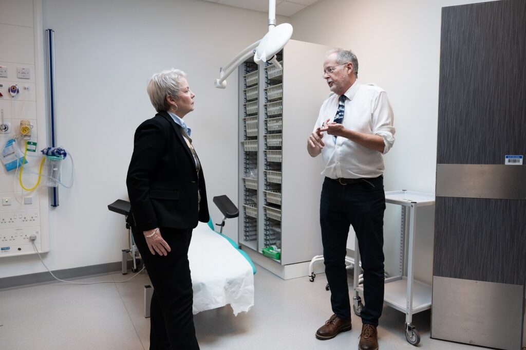 An image of Professor Chris Twelves speaking with minister Karin Smyth MP in a clinical room.