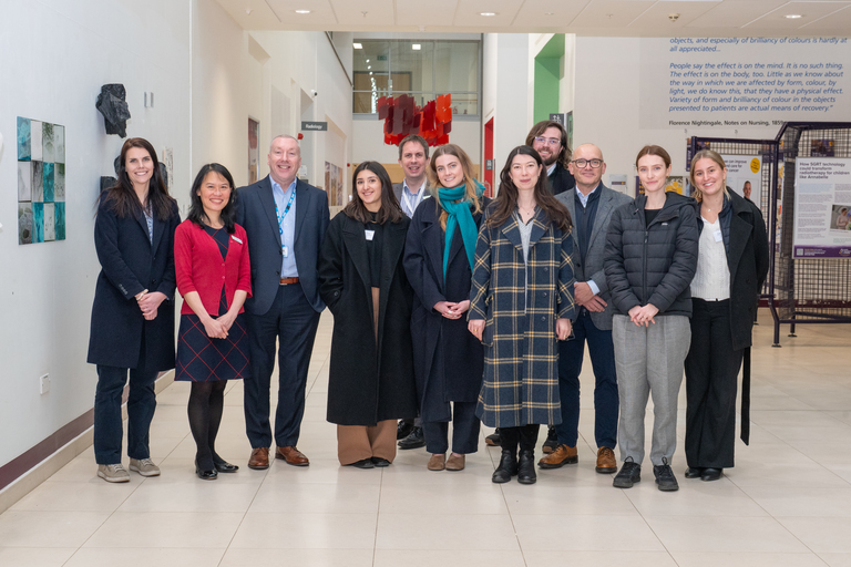 A photo of the visitors in the hospital atrium along with key members of the Trust's executive and senior team from Research & Innovation.